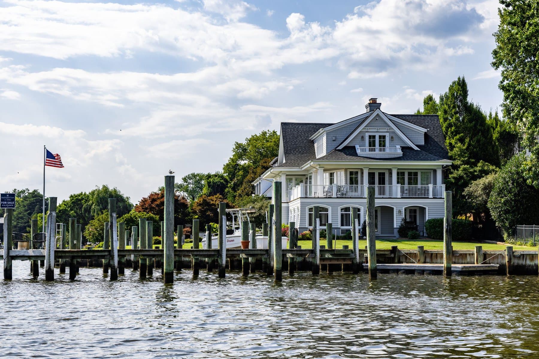 Waterfront vacation home with a private dock and American flag